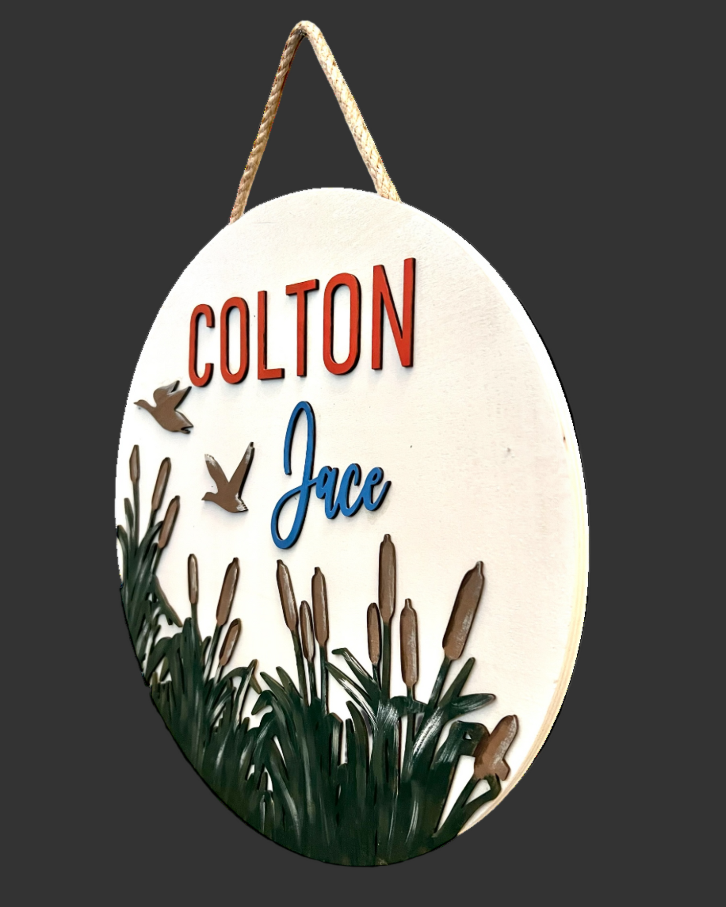 Decorative sign with custom text and cattails design on a white background