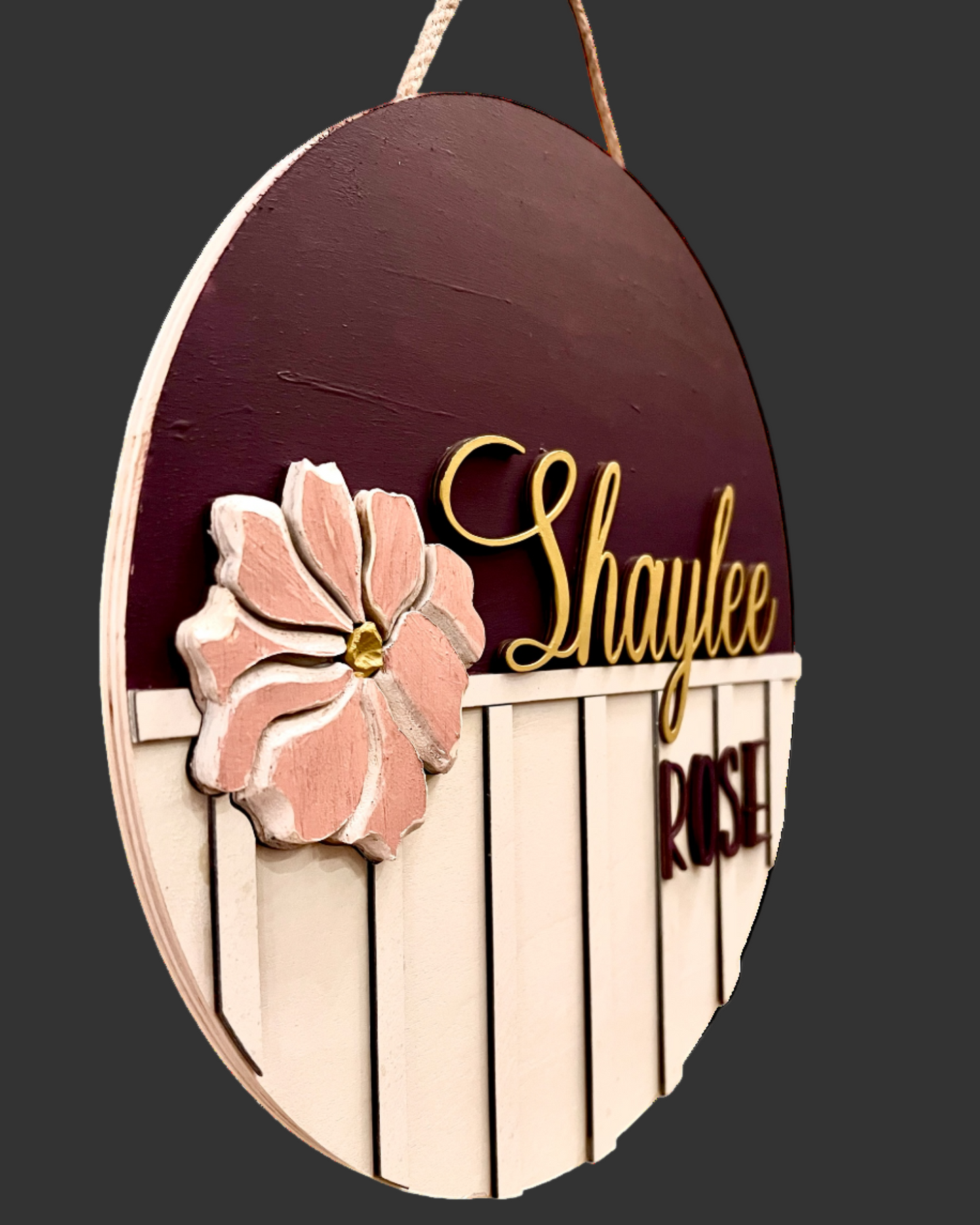 Decorative wooden sign with floral design and 'Shaylee' text on a grey background